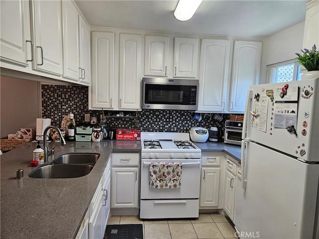 13171 Newland St Unit 11, Garden Grove, CA 92844 - kitchen with white appliances, white cabinetry, and light tile patterned floors