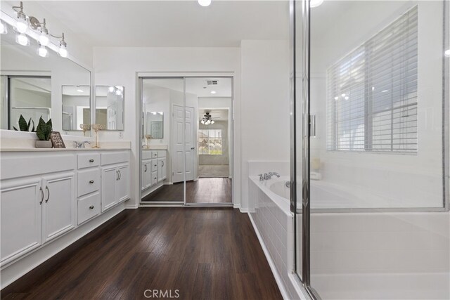 17129 Lacebark St, Fontana, CA 92337 - full bathroom with vanity, a bath, wood finished floors, ceiling fan, and a shower with door