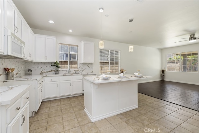 17129 Lacebark St, Fontana, CA 92337 - kitchen featuring white appliances, backsplash, open floor plan, white cabinetry, and recessed lighting