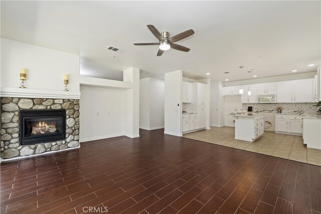 17129 Lacebark St, Fontana, CA 92337 - unfurnished living room featuring a ceiling fan, light wood-type flooring, a fireplace, and recessed lighting