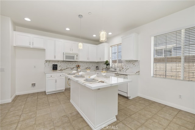 17129 Lacebark St, Fontana, CA 92337 - kitchen featuring white appliances, backsplash, white cabinetry, a kitchen island, and recessed lighting
