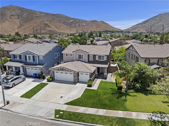 17129 Lacebark St, Fontana, CA 92337 - view of front of property with a tile roof, a residential view, concrete driveway, a mountain view, and a front yard