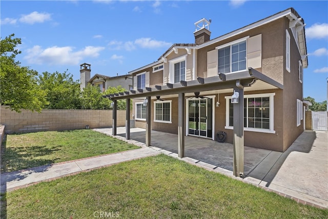 17129 Lacebark St, Fontana, CA 92337 - back of house with stucco siding, a ceiling fan, a fenced backyard, a chimney, and a patio area
