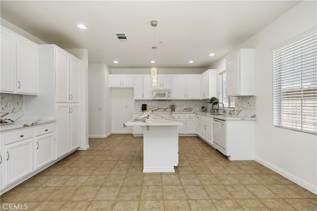 17129 Lacebark St, Fontana, CA 92337 - kitchen with white appliances, tasteful backsplash, white cabinets, light countertops, and recessed lighting