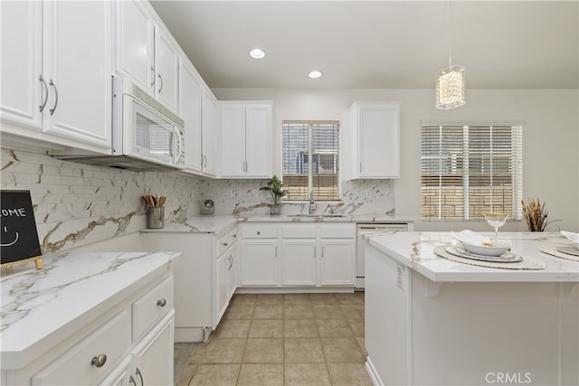 17129 Lacebark St, Fontana, CA 92337 - kitchen featuring white appliances, decorative backsplash, white cabinetry, hanging light fixtures, and recessed lighting