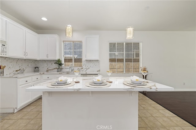 17129 Lacebark St, Fontana, CA 92337 - kitchen featuring light tile patterned flooring, white cabinetry, backsplash, and pendant lighting