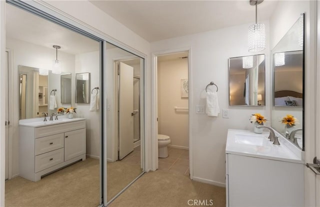 450 Marilyn Ln, Redlands, CA 92373 - bathroom featuring two vanities and a chandelier