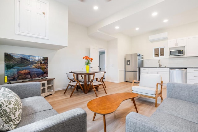 5040 Island View St, Oxnard, CA 93035 - living area with an AC wall unit, light wood-type flooring, and recessed lighting