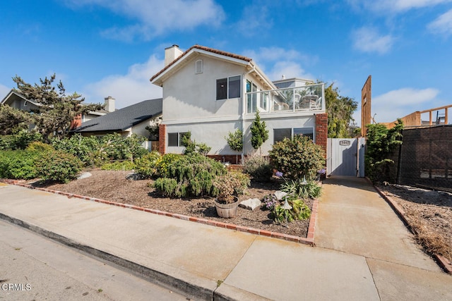 5040 Island View St, Oxnard, CA 93035 - view of front of property featuring a gate, a chimney, stucco siding, and a balcony