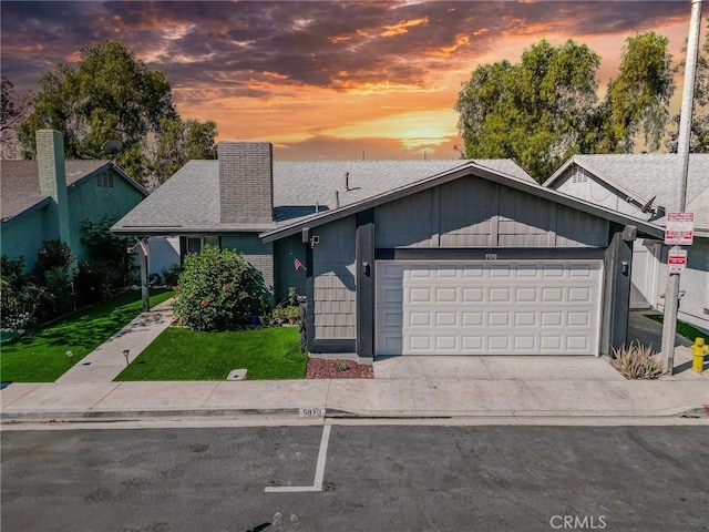 5970 Sky Meadow St, Jurupa Valley, CA 92509 - view of front of house featuring an attached garage, concrete driveway, a shingled roof, and a front lawn