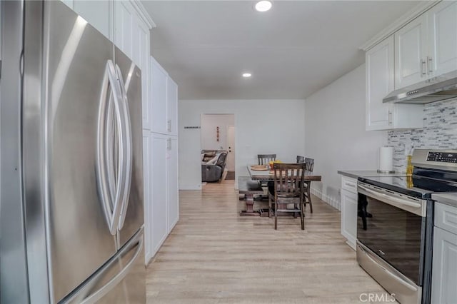 5970 Sky Meadow St, Jurupa Valley, CA 92509 - kitchen featuring stainless steel appliances, under cabinet range hood, tasteful backsplash, light wood-type flooring, and white cabinets