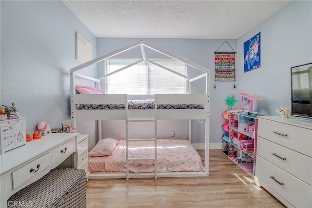 5970 Sky Meadow St, Jurupa Valley, CA 92509 - bedroom featuring a textured ceiling, light wood finished floors, and lofted ceiling