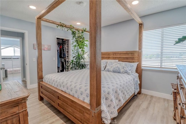 5970 Sky Meadow St, Jurupa Valley, CA 92509 - bedroom featuring light wood-type flooring, a textured ceiling, a spacious closet, and recessed lighting