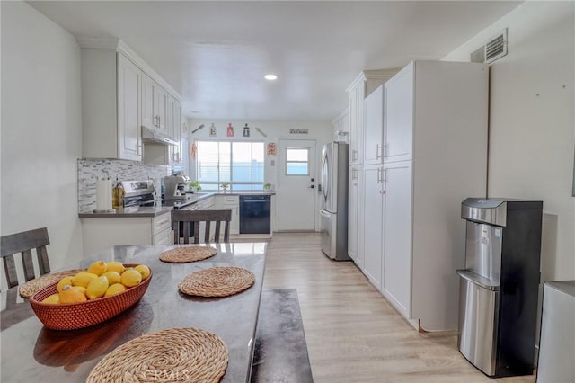 5970 Sky Meadow St, Jurupa Valley, CA 92509 - kitchen with appliances with stainless steel finishes, under cabinet range hood, light wood finished floors, white cabinetry, and recessed lighting
