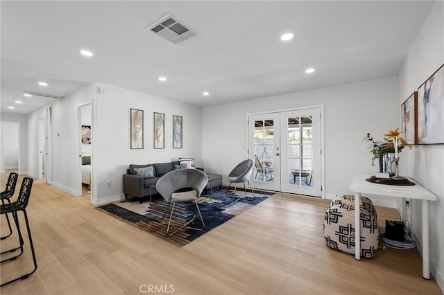 5676 Aztec Ave Unit 29, Palms, CA 92277 - living room with french doors, light wood-type flooring, and recessed lighting