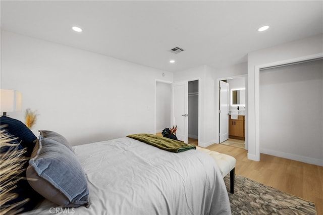 5676 Aztec Ave Unit 29, Palms, CA 92277 - bedroom featuring light wood-style flooring, recessed lighting, and ensuite bath