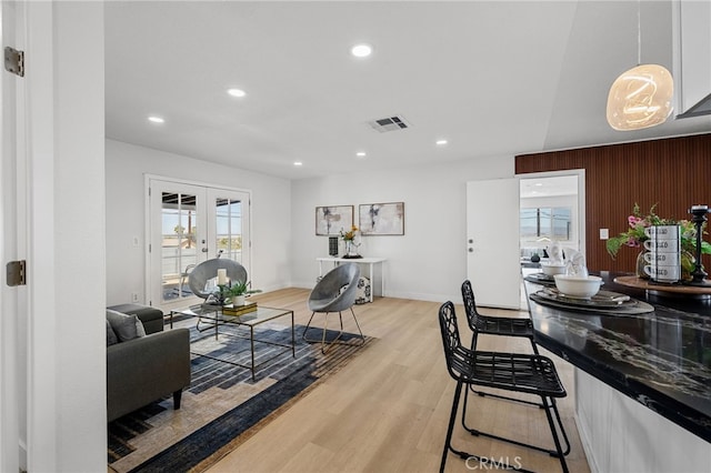 5676 Aztec Ave Unit 29, Palms, CA 92277 - living area featuring light wood-type flooring, recessed lighting, and french doors