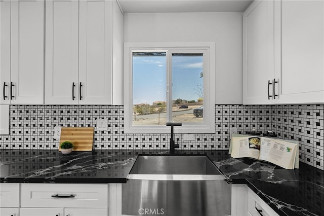 5676 Aztec Ave Unit 29, Palms, CA 92277 - kitchen with white cabinetry and tasteful backsplash