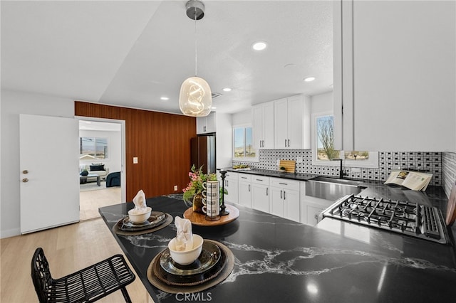 5676 Aztec Ave Unit 29, Palms, CA 92277 - kitchen with freestanding refrigerator, white cabinets, recessed lighting, tasteful backsplash, and dark countertops