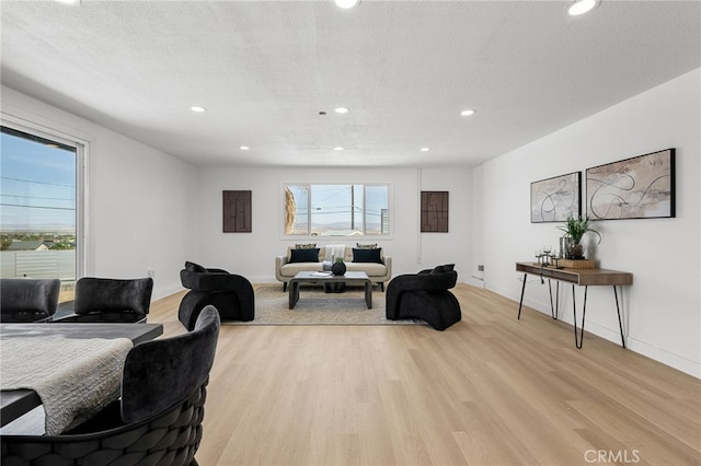 5676 Aztec Ave Unit 29, Palms, CA 92277 - living room with light wood-style flooring and recessed lighting
