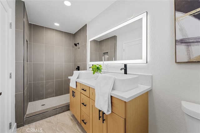 5676 Aztec Ave Unit 29, Palms, CA 92277 - full bath featuring a tile shower, double vanity, marble finish floors, and recessed lighting