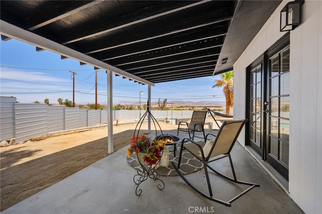5676 Aztec Ave Unit 29, Palms, CA 92277 - view of patio / terrace featuring an outdoor fire pit and french doors