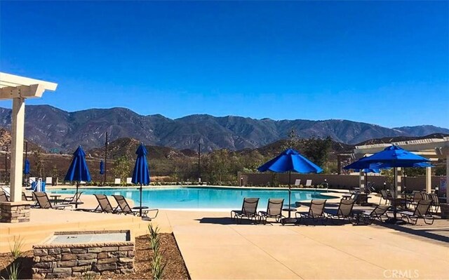 4106 Irish Moss Ln, San Bernardino, CA 92407 - community pool featuring a mountain view and a patio