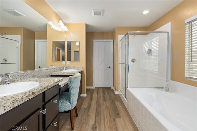 4106 Irish Moss Ln, San Bernardino, CA 92407 - full bathroom with a shower stall, double vanity, a bath, and wood finished floors