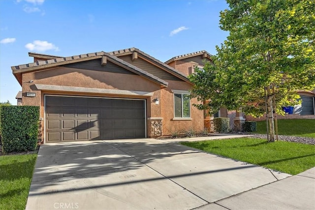 4106 Irish Moss Ln, San Bernardino, CA 92407 - view of front of house featuring a garage, driveway, stucco siding, a front lawn, and a tiled roof