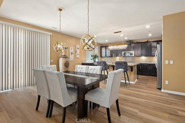 4106 Irish Moss Ln, San Bernardino, CA 92407 - dining space featuring light wood-style flooring, a chandelier, and recessed lighting