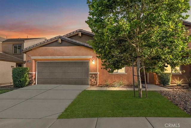 4106 Irish Moss Ln, San Bernardino, CA 92407 - view of front facade with an attached garage, driveway, a lawn, stone siding, and a tiled roof