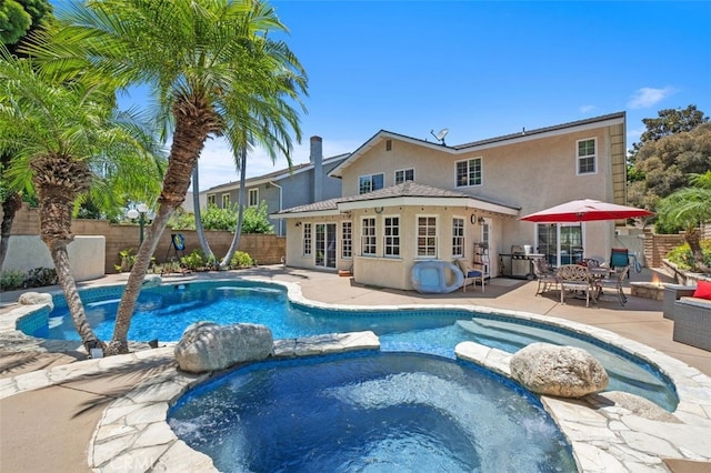 25572 Orchard Rim Ln, Lake Forest, CA 92630 - view of pool with a patio area, a fenced backyard, a pool with connected hot tub, and french doors