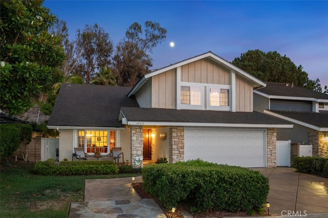 25572 Orchard Rim Ln, Lake Forest, CA 92630 - view of front facade featuring stone siding, a garage, and driveway