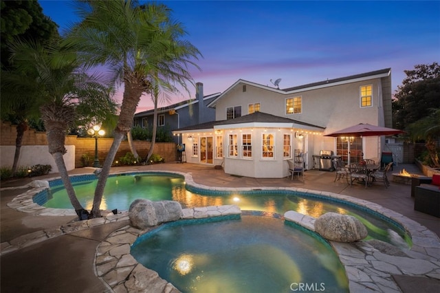 25572 Orchard Rim Ln, Lake Forest, CA 92630 - view of pool with a fire pit, a patio, a fenced backyard, a pool with connected hot tub, and french doors
