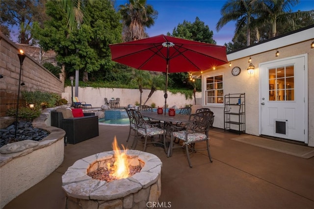 25572 Orchard Rim Ln, Lake Forest, CA 92630 - patio terrace at dusk with a fire pit, a patio, and outdoor dining area