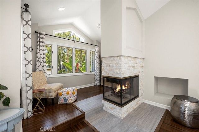 24932 Dove Tree Ln, Lake Forest, CA 92630 - living area with lofted ceiling, a stone fireplace, and wood finished floors