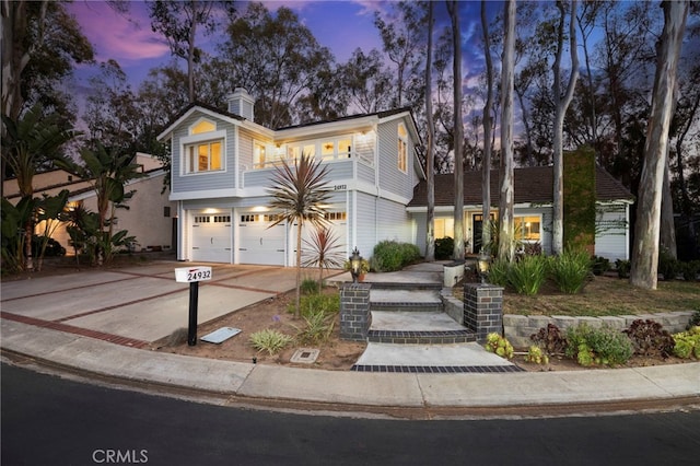 24932 Dove Tree Ln, Lake Forest, CA 92630 - view of front of house featuring an attached garage, concrete driveway, and a chimney