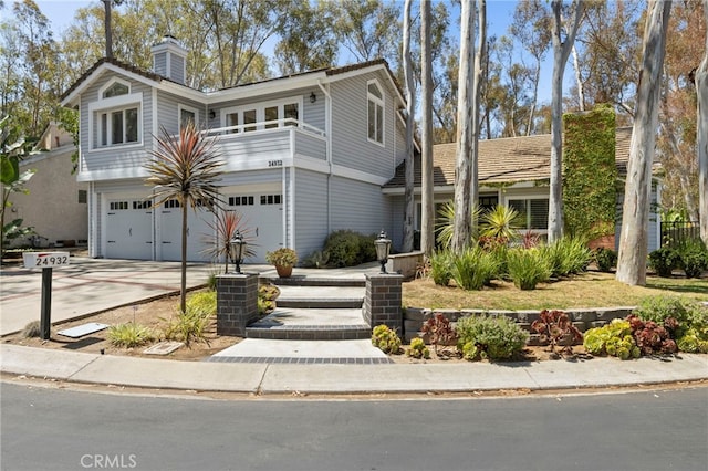 24932 Dove Tree Ln, Lake Forest, CA 92630 - view of front of home with an attached garage, concrete driveway, and a chimney