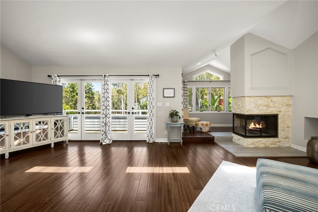 24932 Dove Tree Ln, Lake Forest, CA 92630 - living room featuring vaulted ceiling, french doors, a stone fireplace, and hardwood / wood-style floors