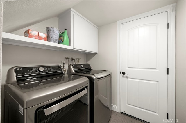 24932 Dove Tree Ln, Lake Forest, CA 92630 - laundry room featuring separate washer and dryer, cabinet space, a textured ceiling, and wood finished floors