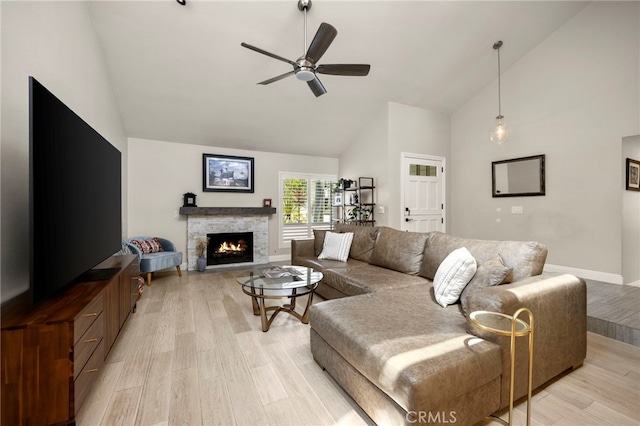 24932 Dove Tree Ln, Lake Forest, CA 92630 - living room featuring high vaulted ceiling, light wood finished floors, a ceiling fan, and a stone fireplace