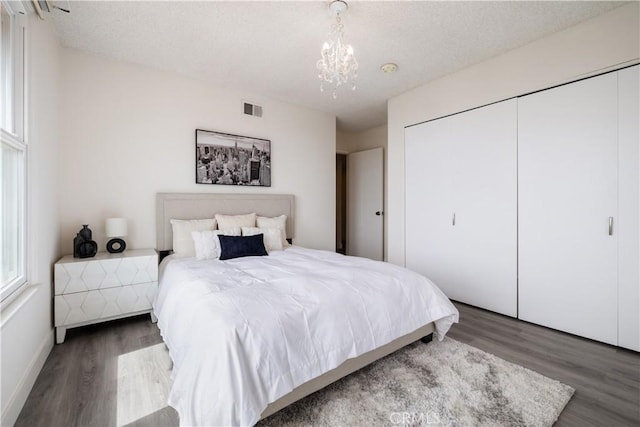 6935 Verde Ridge Rd, Rancho Palos Verdes, CA 90275 - bedroom featuring wood finished floors, a closet, a chandelier, and a textured ceiling