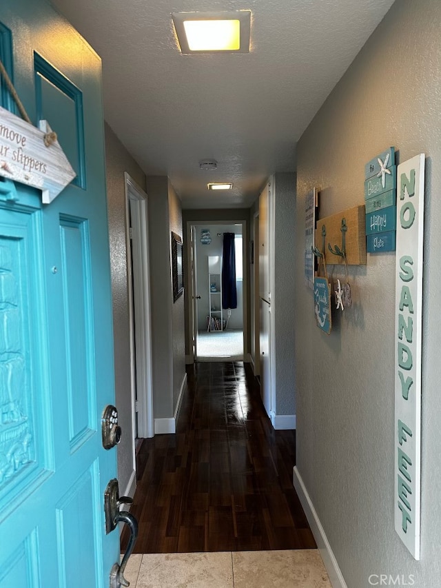518 Avenida Victoria Unit A, San Clemente, CA 92672 - corridor with dark wood-type flooring and a textured wall