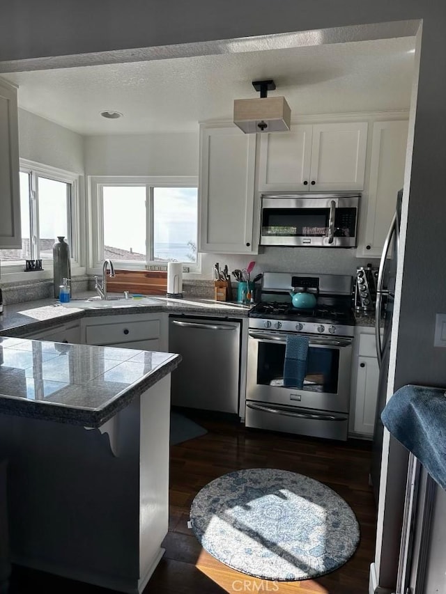 518 Avenida Victoria Unit A, San Clemente, CA 92672 - kitchen featuring appliances with stainless steel finishes, tile countertops, white cabinets, and dark wood-style floors