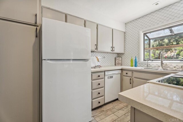 17177 Bernardo Center Dr, San Diego, CA 92128 - kitchen with white appliances, light countertops, backsplash, and light wood-style flooring