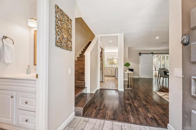 17177 Bernardo Center Dr, San Diego, CA 92128 - entryway featuring a barn door, stairs, and wood-type flooring