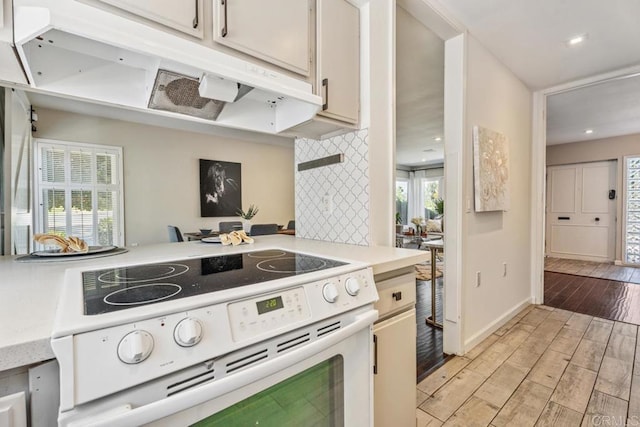 17177 Bernardo Center Dr, San Diego, CA 92128 - kitchen featuring white electric range oven, light countertops, light wood-type flooring, decorative backsplash, and recessed lighting