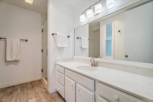 17177 Bernardo Center Dr, San Diego, CA 92128 - bathroom with vanity, hardwood / wood-style flooring, and a stall shower