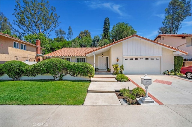 26501 Cortina Dr, Mission Viejo, CA 92691 - view of front of property featuring an attached garage, driveway, a front yard, and a tiled roof