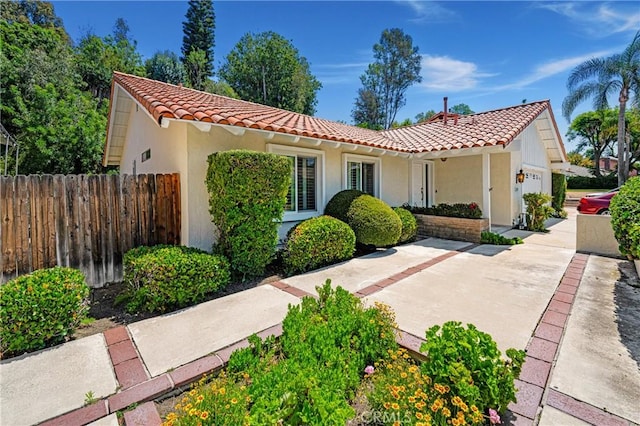 26501 Cortina Dr, Mission Viejo, CA 92691 - mediterranean / spanish-style house with a tiled roof, an attached garage, and stucco siding